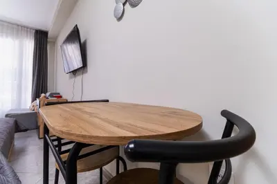 a wooden table in a living room with a couch at City Center Studio Apartments in Plovdiv