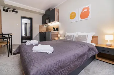 a bedroom with a large bed with towels on it at City Center Studio Apartments in Plovdiv