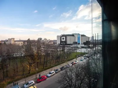 a view of a city with cars parked on a road at Center Square Vitosha Blvd Panorama in Sofia