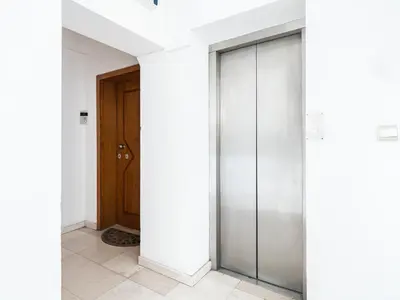 a hallway with white walls and a door at Center Square Vitosha Blvd Panorama in Sofia