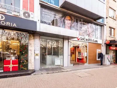 a store front with a christmas tree in the window at Center Square Vitosha Blvd Panorama in Sofia