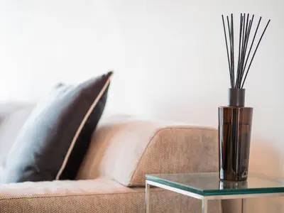 a vase on a glass table next to a couch at Center Square Vitosha Blvd Panorama in Sofia
