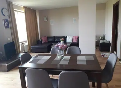 a living room with a wooden table and chairs at Apartament by Zenit in Terra Complex Massonet D28 near Bansko in Razlog