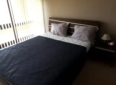 a bedroom with a large bed with two pillows at Apartament by Zenit in Terra Complex Massonet D28 near Bansko in Razlog