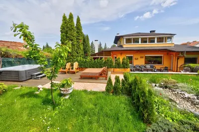 a house with a backyard with a patio at Villa Boyana City & Relax with Hot Jacuzzi and Sauna by BookVillaBG in Sofia