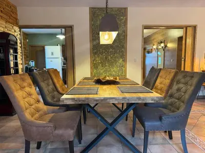 a dining room with a table and leather chairs at Villa Boyana City & Relax with Hot Jacuzzi and Sauna by BookVillaBG in Sofia