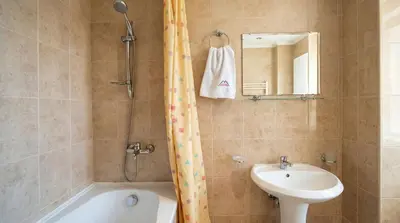 a bathroom with a tub and a sink and a shower at South Facing Bright Mountain View Penthouse - 2 balconies, 300mbps WIFI, washer in Bansko
