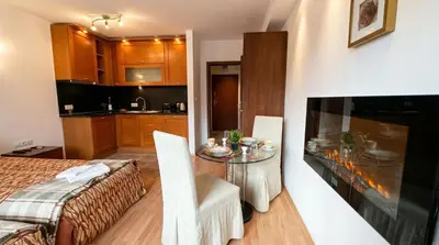a kitchen and a dining room with a table in a room at South Facing Bright Mountain View Penthouse - 2 balconies, 300mbps WIFI, washer in Bansko