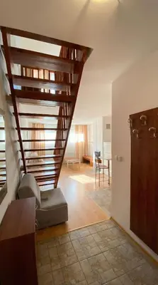 a living room with a spiral staircase in a house at 1BR Bright 300mbps WIFI Duplex - Two Floors in Bansko