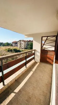 a balcony of a house with a wooden door at 1BR Bright 300mbps WIFI Duplex - Two Floors in Bansko