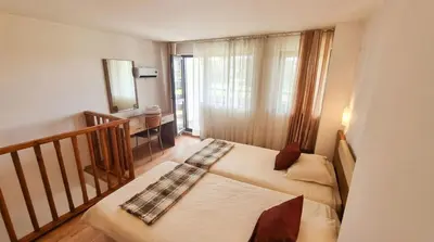 a small bedroom with two beds and a balcony at 1BR Bright 300mbps WIFI Duplex - Two Floors in Bansko