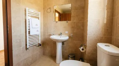 a bathroom with a sink and a toilet and a mirror at 1BR Bright 300mbps WIFI Duplex - Two Floors in Bansko