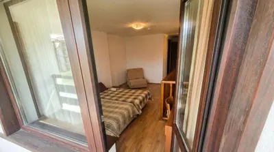 a small room with a couch and a window at 1BR Bright 300mbps WIFI Duplex - Two Floors in Bansko