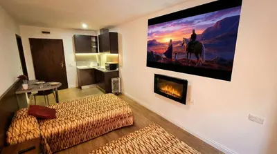 a living room with a large painting on the wall at Mountain Paradise 2 - Quiet Cosy Studio - Balcony, Wifi in Bansko