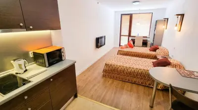 a room with two beds and a kitchen with a sink at Mountain Paradise 2 - Quiet Cosy Studio - Balcony, Wifi in Bansko