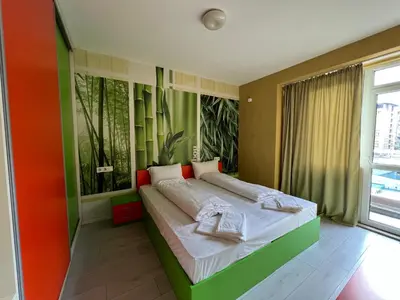 a bedroom with a large bed in a room at APARTHOTEL VICTORY SOFIA in Sofia