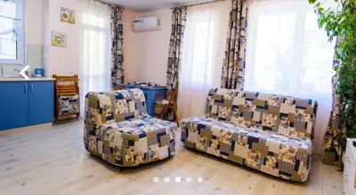 a living room with two chairs and a couch at APARTHOTEL VICTORY SOFIA in Sofia