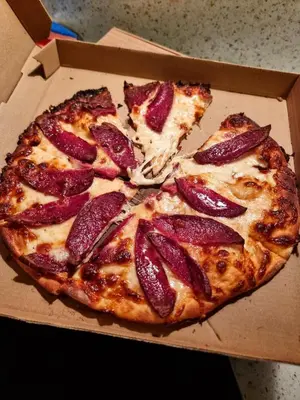 two slices of pizza in a box at Mountain Paradise 1 - 1 Bedroom South facing balcony - 300mbps Wi-fi in Bansko