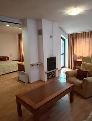 a living room with a couch and a coffee table at Mountain Paradise 1 - 1 Bedroom South facing balcony - 300mbps Wi-fi in Bansko