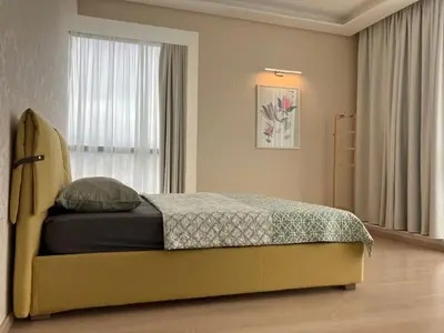 a bedroom with a bed and a window at Point Sofia Grand Suite in Sofia