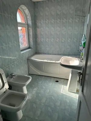 a bathroom with a sink and a tub and a toilet at Славина къща in Perushtitsa