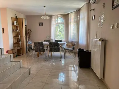 a dining room with a table and chairs at Славина къща in Perushtitsa
