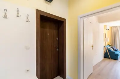 a hallway with a brown door in a room at Central located 1BDR peaceful apt Fast Wi-fi in Sofia