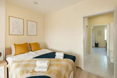a bedroom with a large bed with towels on it at Central located 1BDR peaceful apt Fast Wi-fi in Sofia