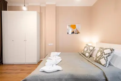 a bedroom with a bed with towels on it at Top Centre 1 Bedroom Apt next to Vitosha Blvd. in Sofia