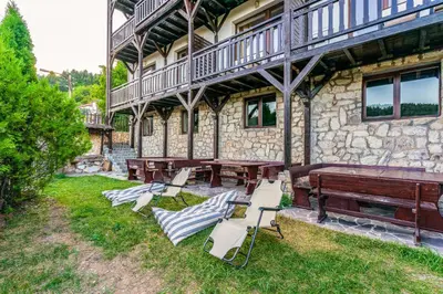 a group of chairs and tables in front of a building at The Pine Living - Ski & SPA in Lyevochevo