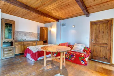a living room with a table and a couch at The Pine Living - Ski & SPA in Lyevochevo