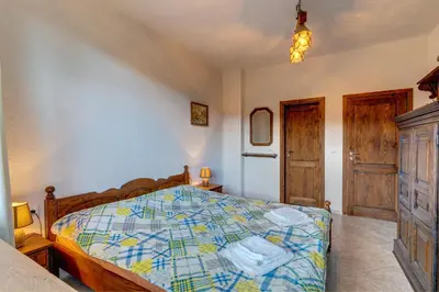 a bedroom with a bed with a colorful comforter at The Pine Living - Ski & SPA in Lyevochevo