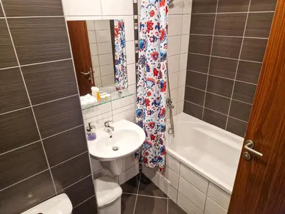 a bathroom with a sink and a toilet and a bath tub at Sunny Apartment C25 in Borovets