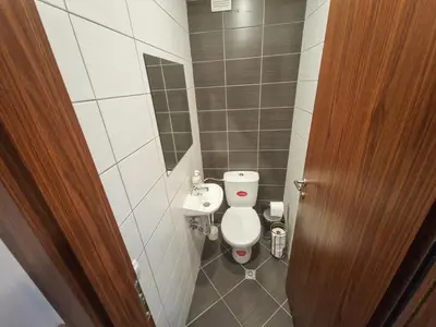 a small bathroom with a toilet and a sink at Sunny Apartment C25 in Borovets