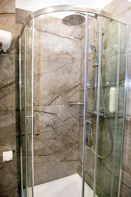 a shower with a glass enclosure in a bathroom at Agora Boutique Hotel in Sofia