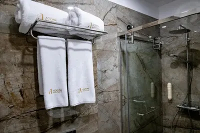 a bathroom with white towels and a shower at Agora Boutique Hotel in Sofia