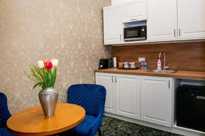 a kitchen with a table with a vase of flowers on it at Agora Boutique Hotel in Sofia