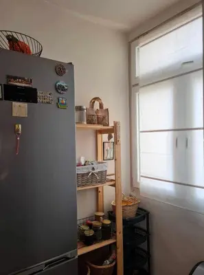 a kitchen with a refrigerator and a window and shelves at Specious Modern Apartment in Sofia