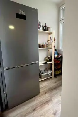a kitchen with a stainless steel refrigerator in a room at Specious Modern Apartment in Sofia