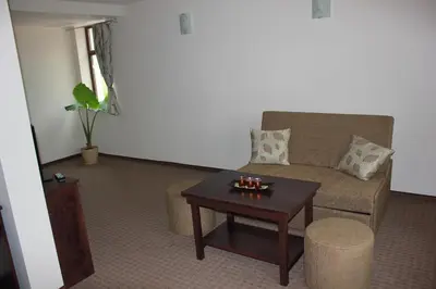 a living room with a couch and a coffee table at Hotel Podkovata in Etropole