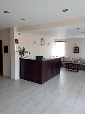 a waiting room with a reception desk in a hospital at Hotel Podkovata in Etropole