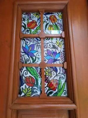a glass window with colorful flowers on a door at Serdika Old City House in Sofia
