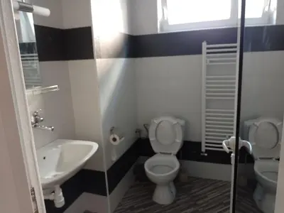 a bathroom with a toilet and a sink at Цвят бяло in Sofia