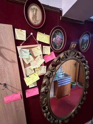 a mirror on a wall with sticky notes at Sleep & fly in Sofia