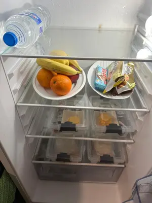 a refrigerator filled with fruit and a bottle of water at Sleep & fly in Sofia