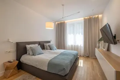 a bedroom with a bed and a flat screen tv at Top-Notch location, an Exceptionally Stylish flat in Sofia