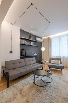 a living room with a couch and a table at Top-Notch location, an Exceptionally Stylish flat in Sofia