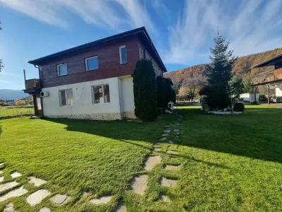 a house on a grassy yard with a pathway at Villa Nikol Apt #2 in Raduil