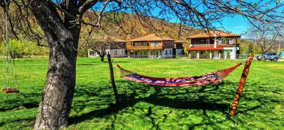 a hammock hanging from a tree in front of a house at Villa Nikol Apt #2 in Raduil