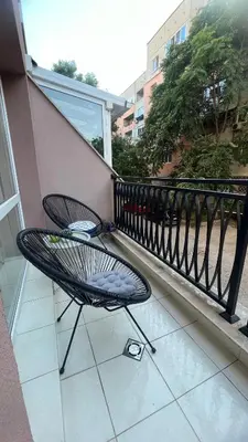 a chair sitting on the balcony of a building at Soflu apartments Plovdiv in Plovdiv
